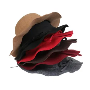Detailed stack of wool fedora hats with elegant wavy brims and bow accents in multiple colors
