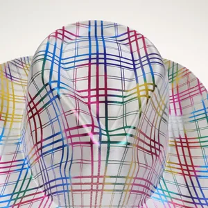 Macro shot of colorful rainbow plaid cowboy hat showing vibrant silk-texture fabric details