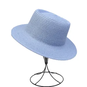 Detail shot showing the fine texture of a light blue flat-top straw boater sun hat