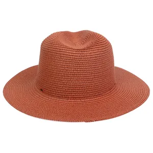 Detail of terracotta straw fedora hat featuring fine spiral weave and breathable texture