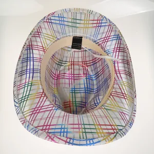 Detail view of colorful glitter stripe pattern and interior polyester wash label on cowboy hat