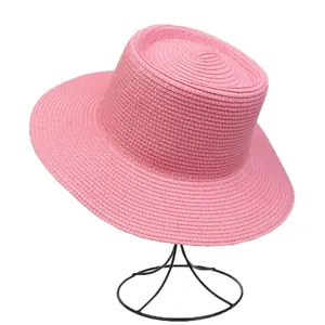 Macro detail of high-quality bright pink straw weave on a classic flat top boater hat