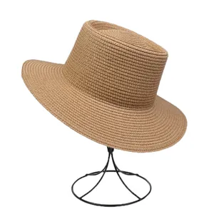 Detail of khaki woven straw boater hat with flat brim on a black display stand