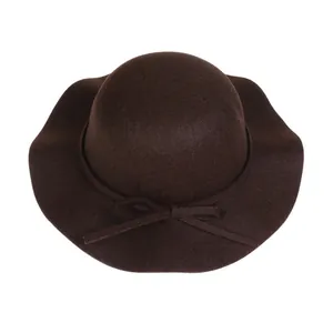Close-up of a dark brown wool felt fedora featuring a wide wavy brim and bow detail