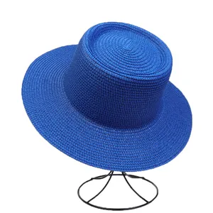 Detail of royal blue boater hat showing fine straw weave texture on metal display stand