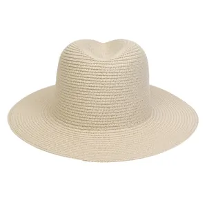 Detailed view of the tight weave texture and classic crown of a beige Fedora straw hat