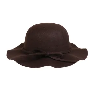 Close-up of elegant dark brown wool felt hat with wavy brim and bow tie detail
