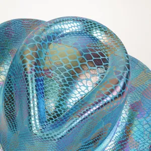 Macro shot of vibrant blue holographic snakeskin texture on a party cowboy hat crown