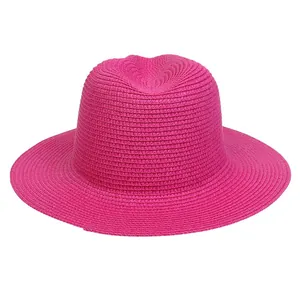 Detail of hot pink straw Panama hat showing intricate woven texture and sun protection brim
