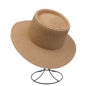 Close-up of the dense woven texture and flat brim of this French style straw boater hat