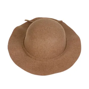 Detail of a brown wool felt dome hat featuring delicate fiber texture and matching ribbon