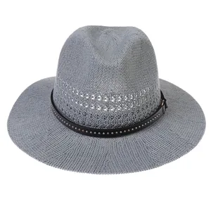 Detail of grey hollow straw fedora hat featuring black leather band and metal rivets