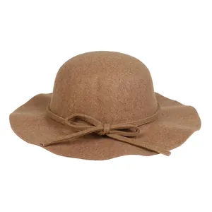 Detailed close-up of brown wool felt cloche hat featuring a delicate ribbon bow accent