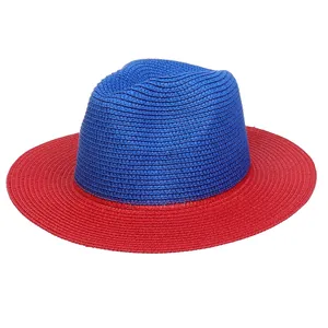Detailed macro shot of blue and red color-blocked woven paper straw panama sun hat