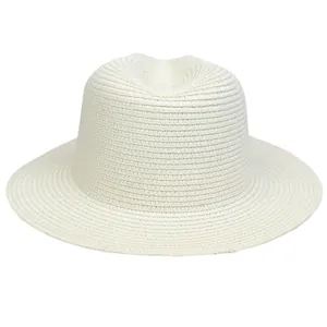 Detail of the woven texture and classic indented crown on a beige straw panama hat