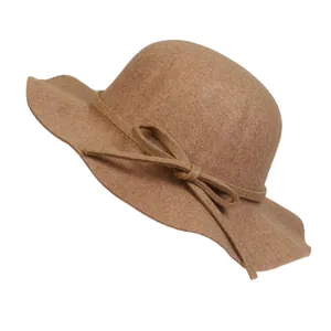 Detail of the elegant camel wool fedora hat with side bow tie and wavy brim