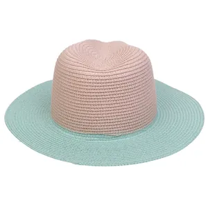 Close-up of pink and mint blue straw weave texture on a wide brim sun hat for summer