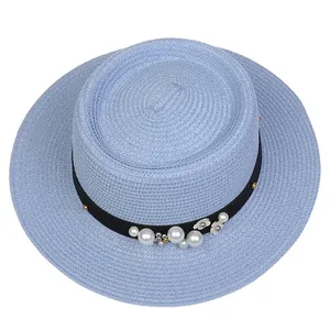 Detail of light blue straw boater hat with elegant pearl and silver flower trim