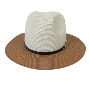 Close-up of the woven texture and black leather strap with gold buckle on a Panama straw hat