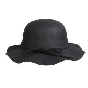 Elegant black wool dome fedora hat with wide wavy brim and delicate bow accent