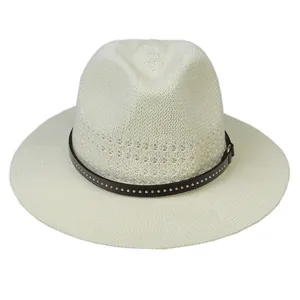 Close-up of woven straw hat with wide brim and leather band with metal rivets