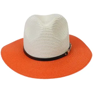 Detailed top view of a woven Panama straw hat featuring a black band with a golden buckle