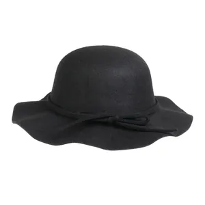 Close-up of black wool dome hat with wavy brim and delicate ribbon bow detail