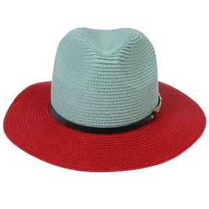 Detailed close-up of woven panama hat with blue crown, red brim and black leather band