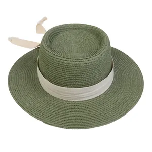 Top view of olive green flat top straw boater hat with cream canvas ribbon tie detail