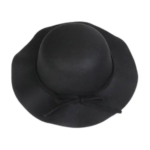 Detail of elegant black wool dome hat with wavy wide brim and ribbon bow for autumn
