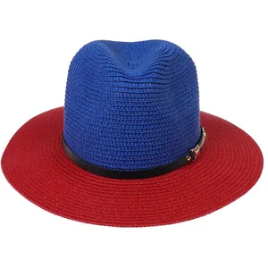 Detail of blue and red panama straw hat featuring a black leather band and gold buckle