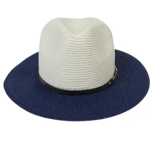 Detail of two-tone straw Panama hat with beige crown, navy brim, and black buckle strap