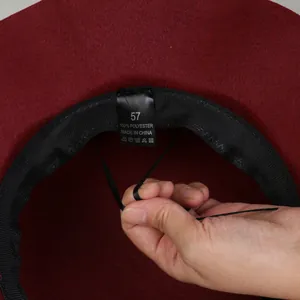 Detail of wool-like hat interior with adjustable drawstring and 100% polyester label