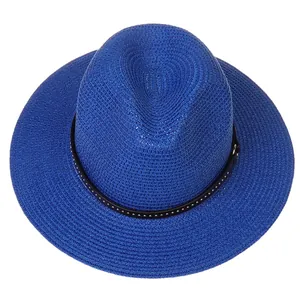 Close-up of vibrant blue straw fedora hat featuring a black ribbon with silver studs