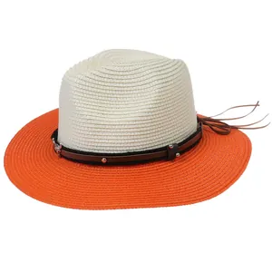 Detail of two-tone woven Panama hat with orange brim and studded faux leather band