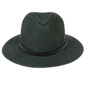 Close-up of a dark green straw fedora hat featuring a black leather band with silver studs