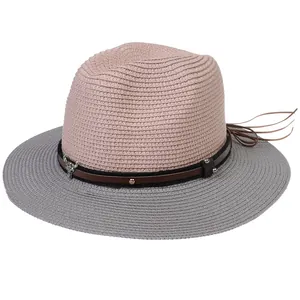 Detail of straw hat with two-tone weave, cow head metal stud and leather band