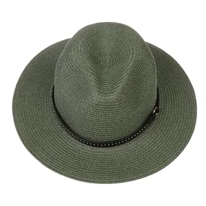 Detailed texture of dark green straw fedora hat with black silver studded band