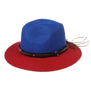Close-up of bicolor straw Panama hat featuring a leather band with silver skull charm and fringe