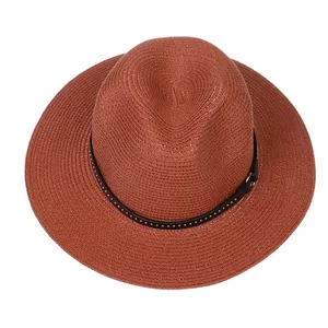 Macro view of woven straw Panama hat texture with a black studded leather band decoration