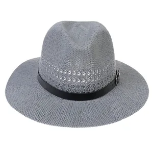 Detail of grey woven straw hat featuring breathable mesh texture and black belted buckle band