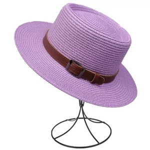 Detailed close-up of a purple straw fedora with a brown leather band on a display stand