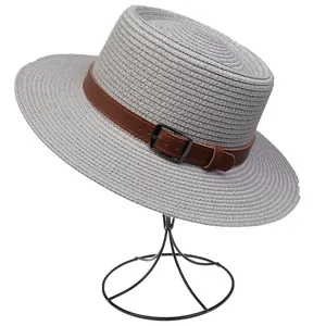 Detail of light gray straw sun hat with brown faux leather belt and metal buckle