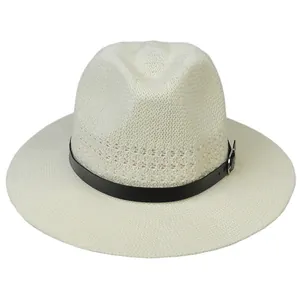 Detail of cream woven straw hat featuring black faux leather band and silver metal buckle