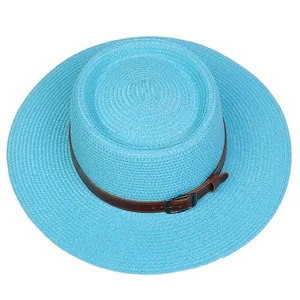 Top view of bright blue boater hat showing woven texture and brown faux leather band
