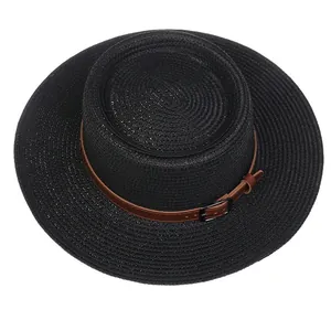 Detail of black boater hat with fine straw weave and brown leather band decoration