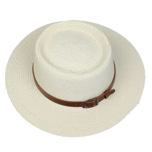 Detail of woven straw hat with brown leather belt and buckle decoration
