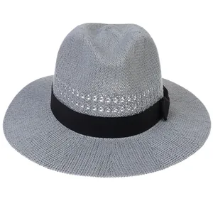 Detail of grey straw fedora hat featuring breathable hollow weaving and black ribbon bow