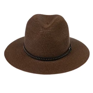 Detail of dark brown fedora straw hat featuring a black leather band with silver studs