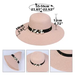 Detail of pink straw sun hat with 10cm wide brim and pearl flower ribbon decoration